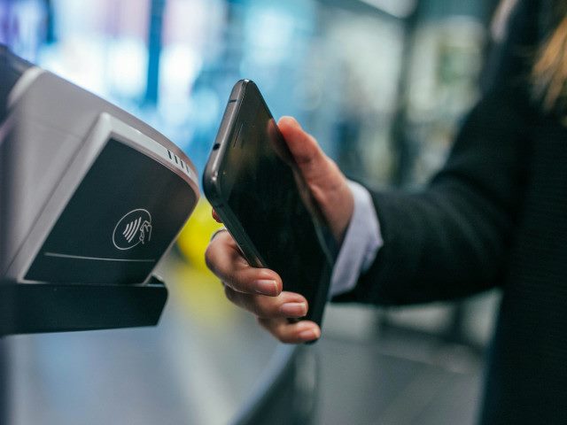 A customer makes a mobile payment with their smartphone.