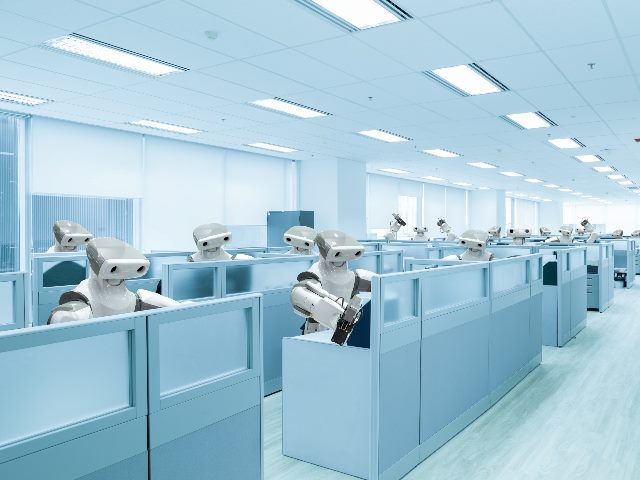 Robot team working in the office instead of humans in cubicles. 