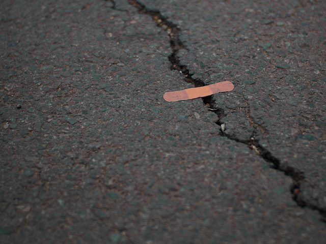 band aid over a crack in the pavement