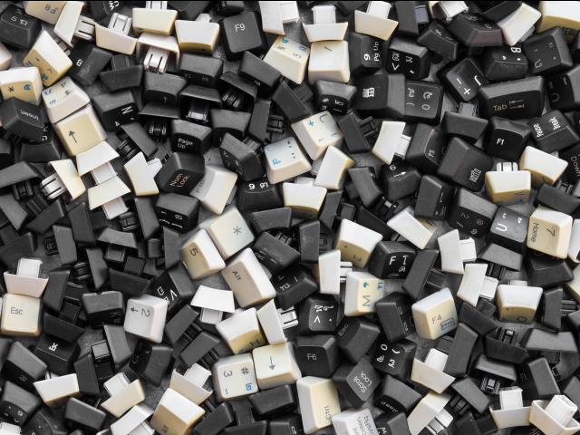 A pile of computer keyboard keys, they are black and white - unstructured data concept