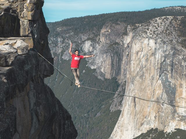 man on a tightrope over a cliff