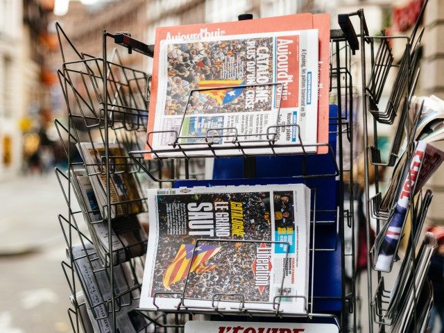 Newspapers on a French newsstand outside featuring news from Spain about the Catalonia Referendum and protests in Barcelona.