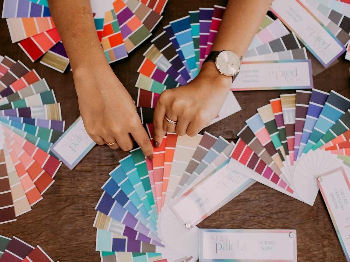 person making a selection from a wide variety of paint chips