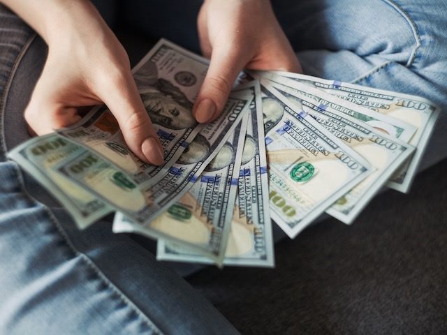 close up of hands counting money 