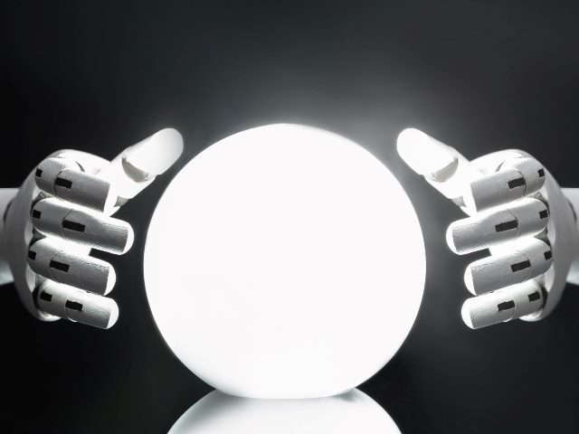 Robot hands encircle a crystal ball as if to tell the future. 