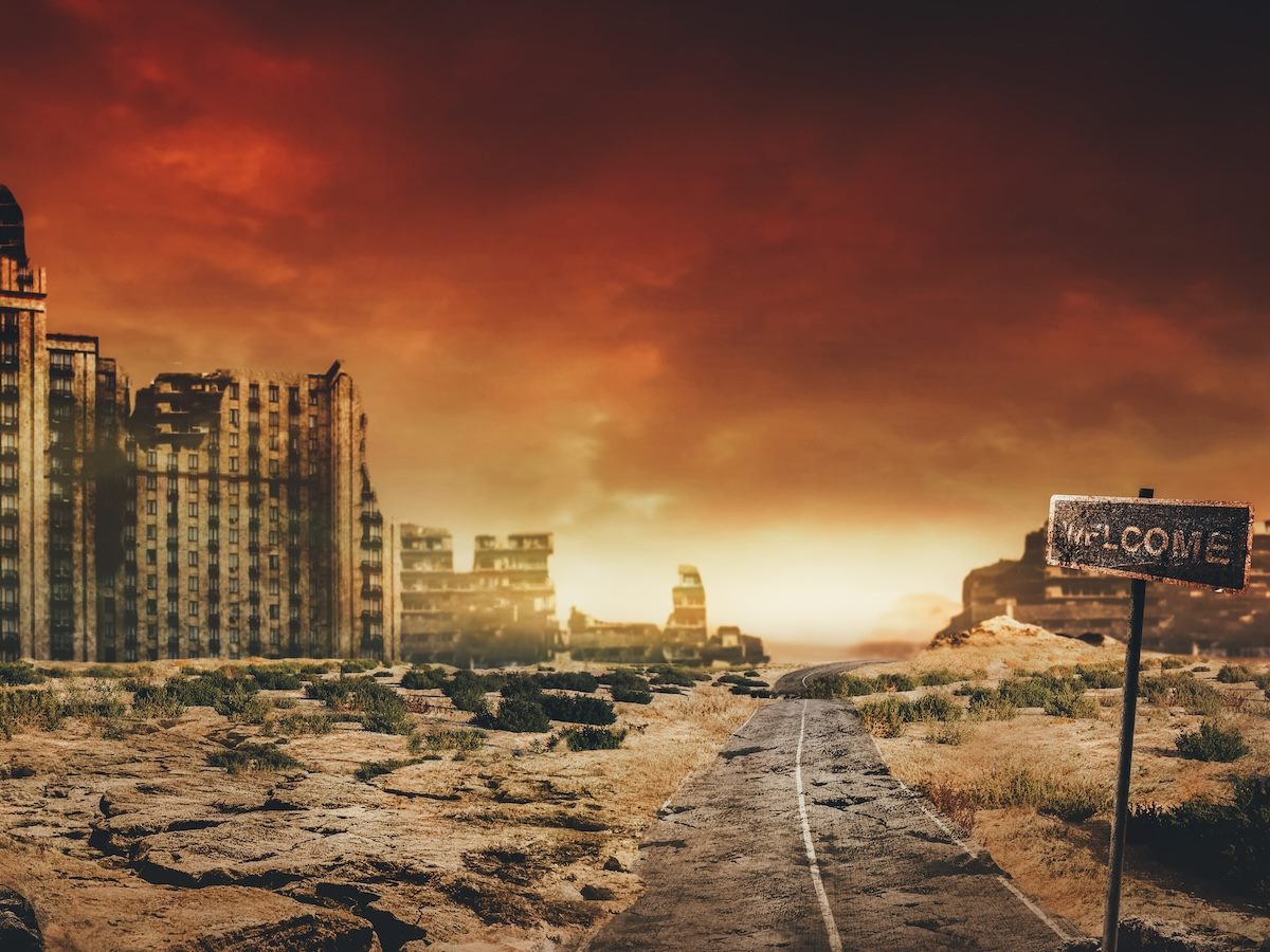 Evening post apocalyptic background image of desert city wasteland with abandoned and destroyed buidings, cracked road and sign