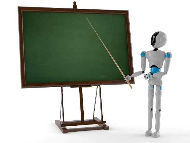 A white robot using a teacher's stick to point at a green chalkboard outlined with a wooden frame.