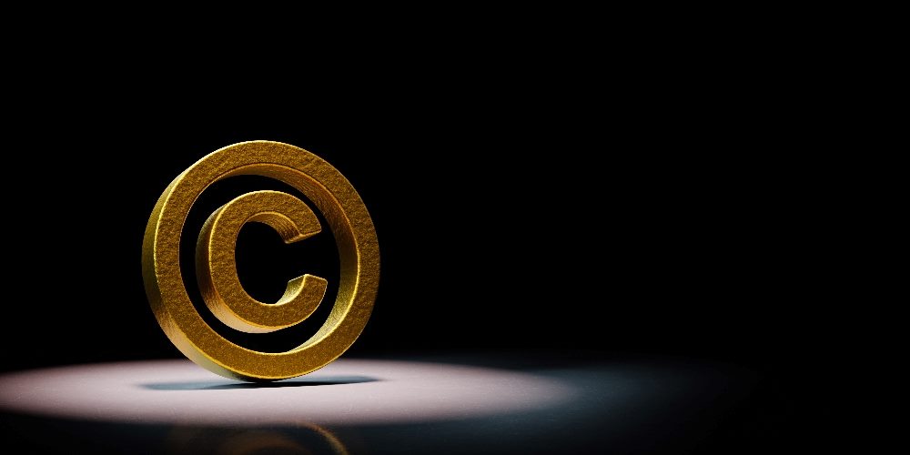 A golden copyright symbol appears on the left against a black background in piece about AI copyright infringement.