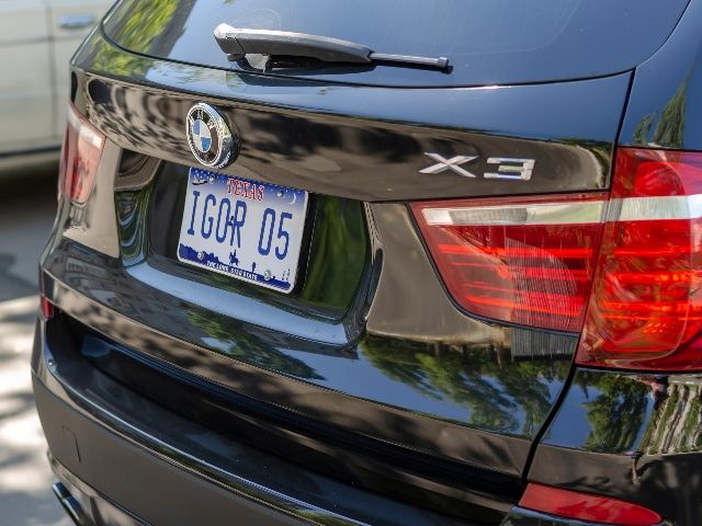 Personalized license plate that says "IGOR" on the rear of BMW X3 car in a parking lot.