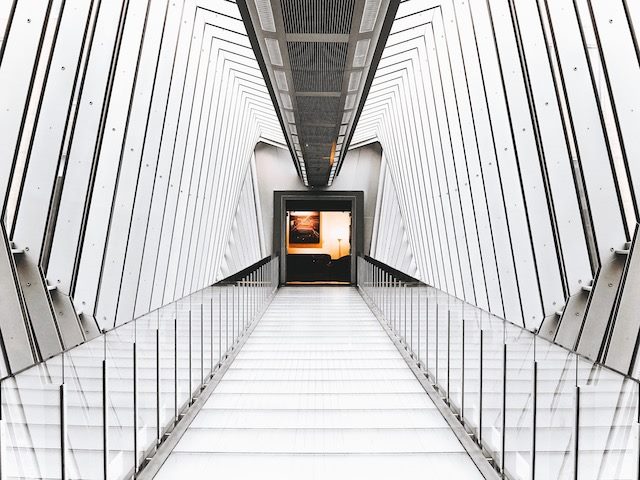hallway with open door into a room at the center of the image