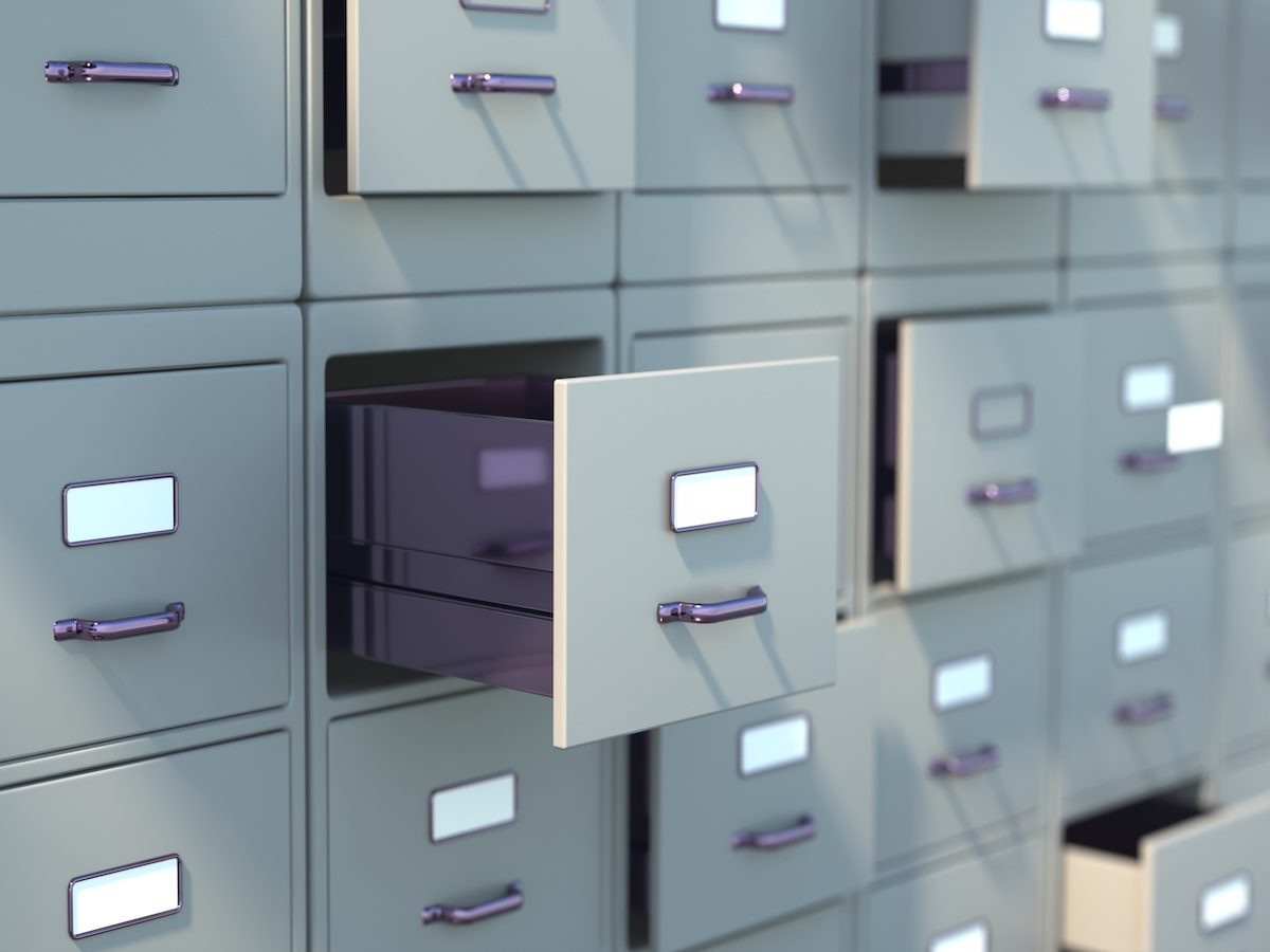 Grey archive file cabinets with some drawers open