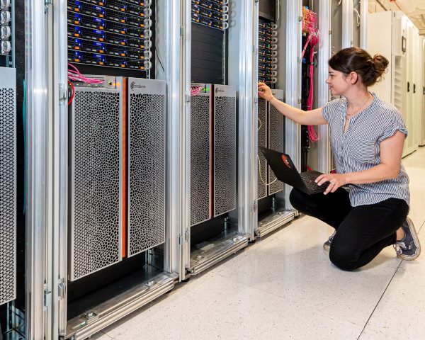 An employee examines a wafer-scale supercomputer cluster by Cerebras Systems.