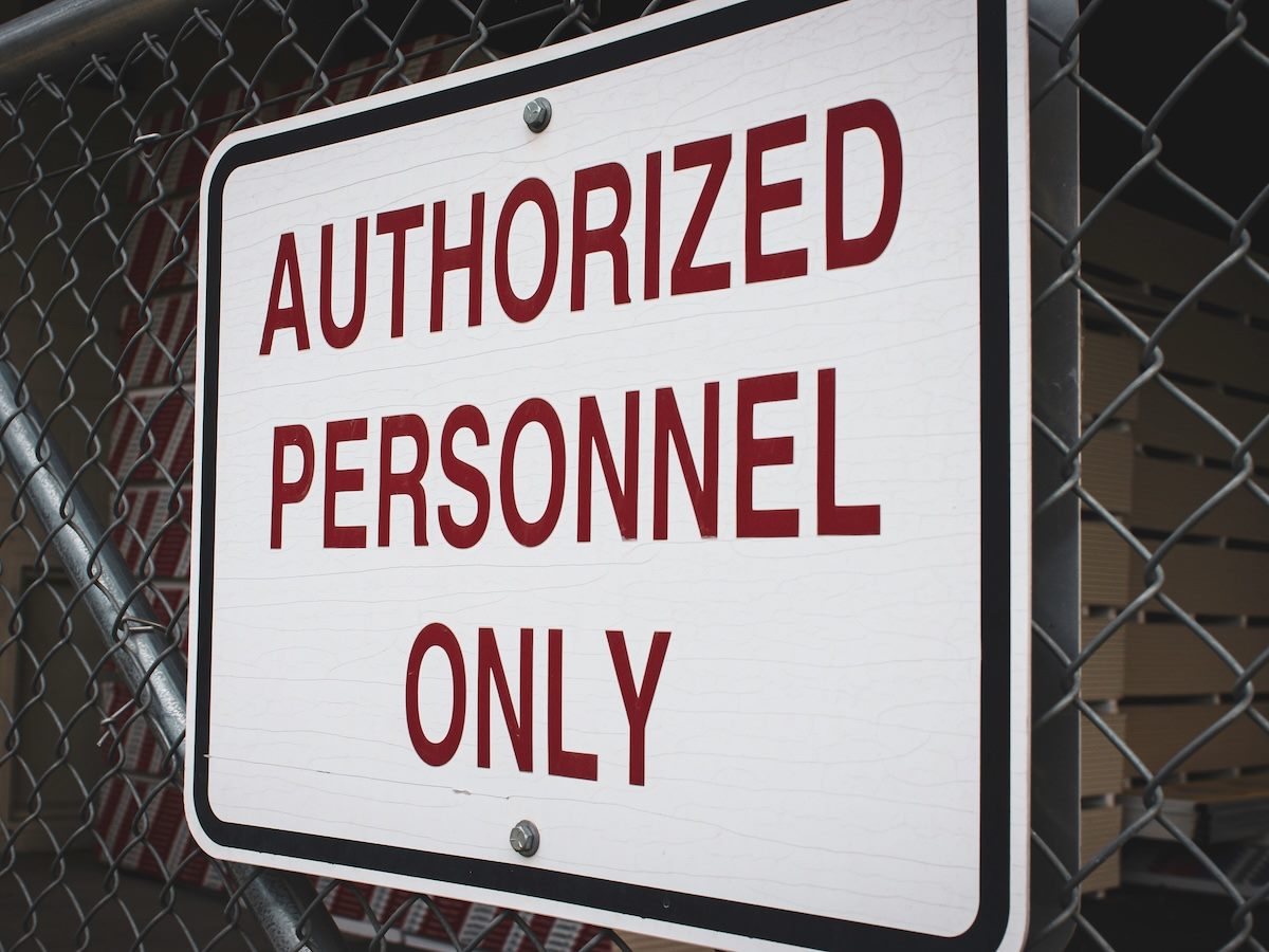 Authorized personnel only sign on fence