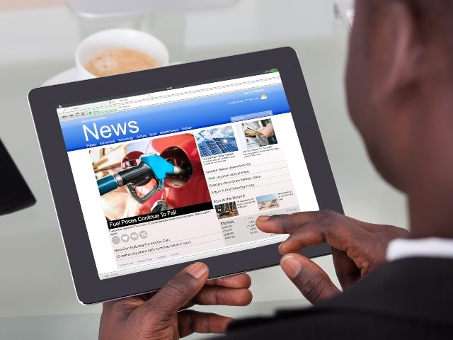 Man reading the news on a tablet.