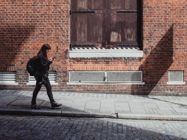 woman staring at phone
