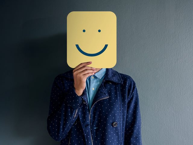 A customer holding a happy face sign over their head - personalized customer experience
