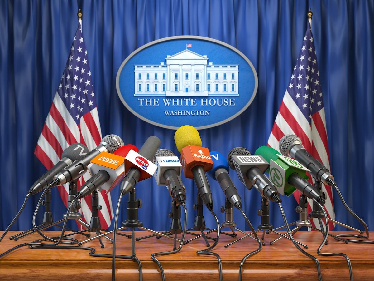 Press conference of president in the White House Washington.  Microphones  of all media with USA flags and White House sign. 3d illustration